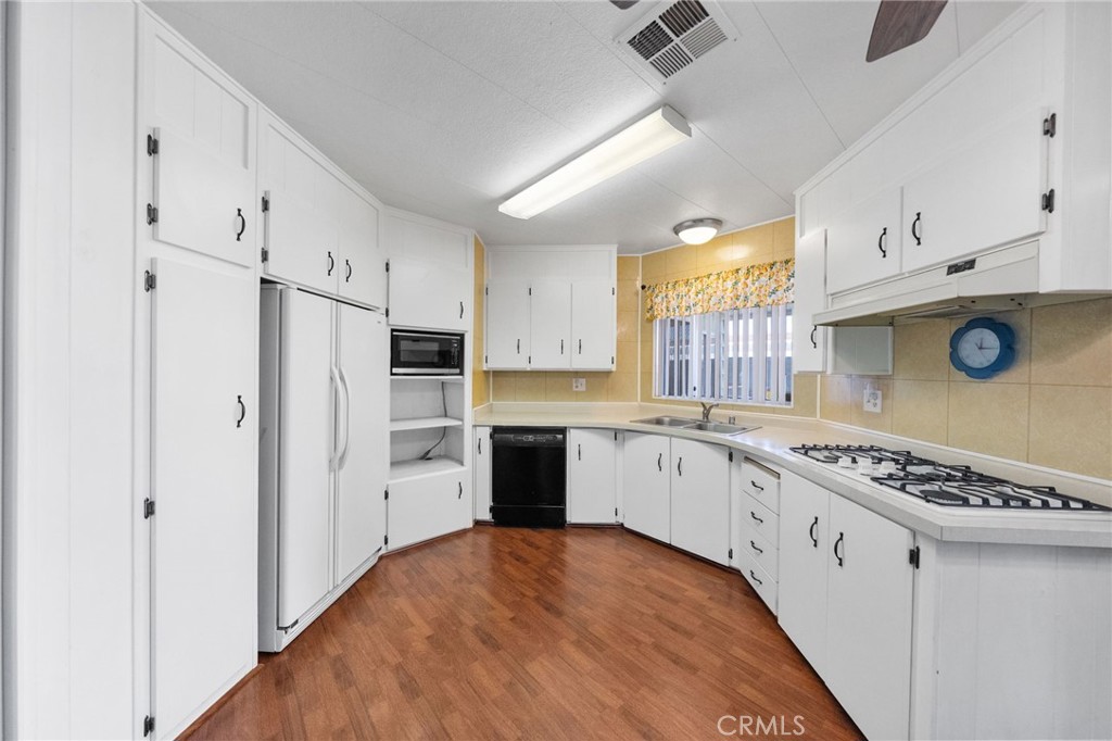 1195 La Moree Road, Unit 36 San Marcos, CA 92078 - Photo 28 of 47 a kitchen with stainless steel appliances granite countertop a stove a refrigerator and a white cabinets