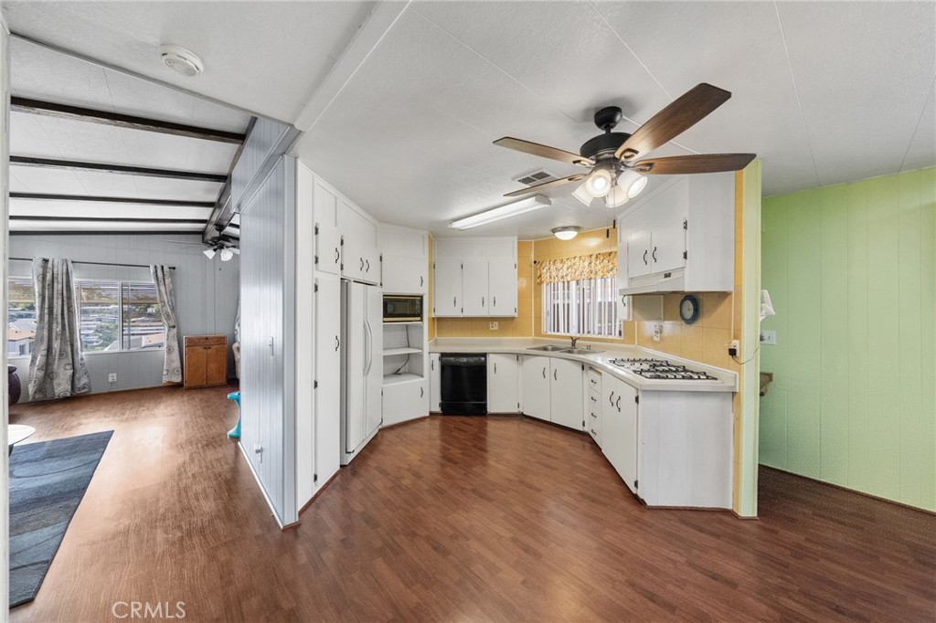 1195 La Moree Road, Unit 36 San Marcos, CA 92078 - Photo 31 of 47 a kitchen with stainless steel appliances a stove a refrigerator and a wooden floor