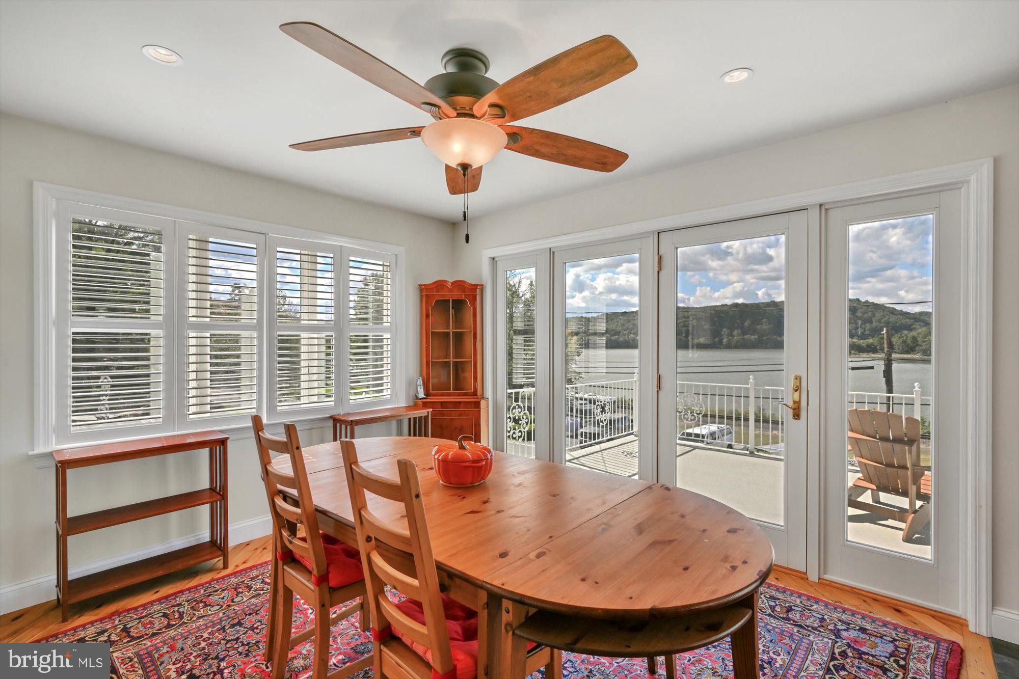 689 Bridge Valley Road Pequea, PA 17565 - Photo 13 of 42 a view of a dining room with furniture window and wooden floor