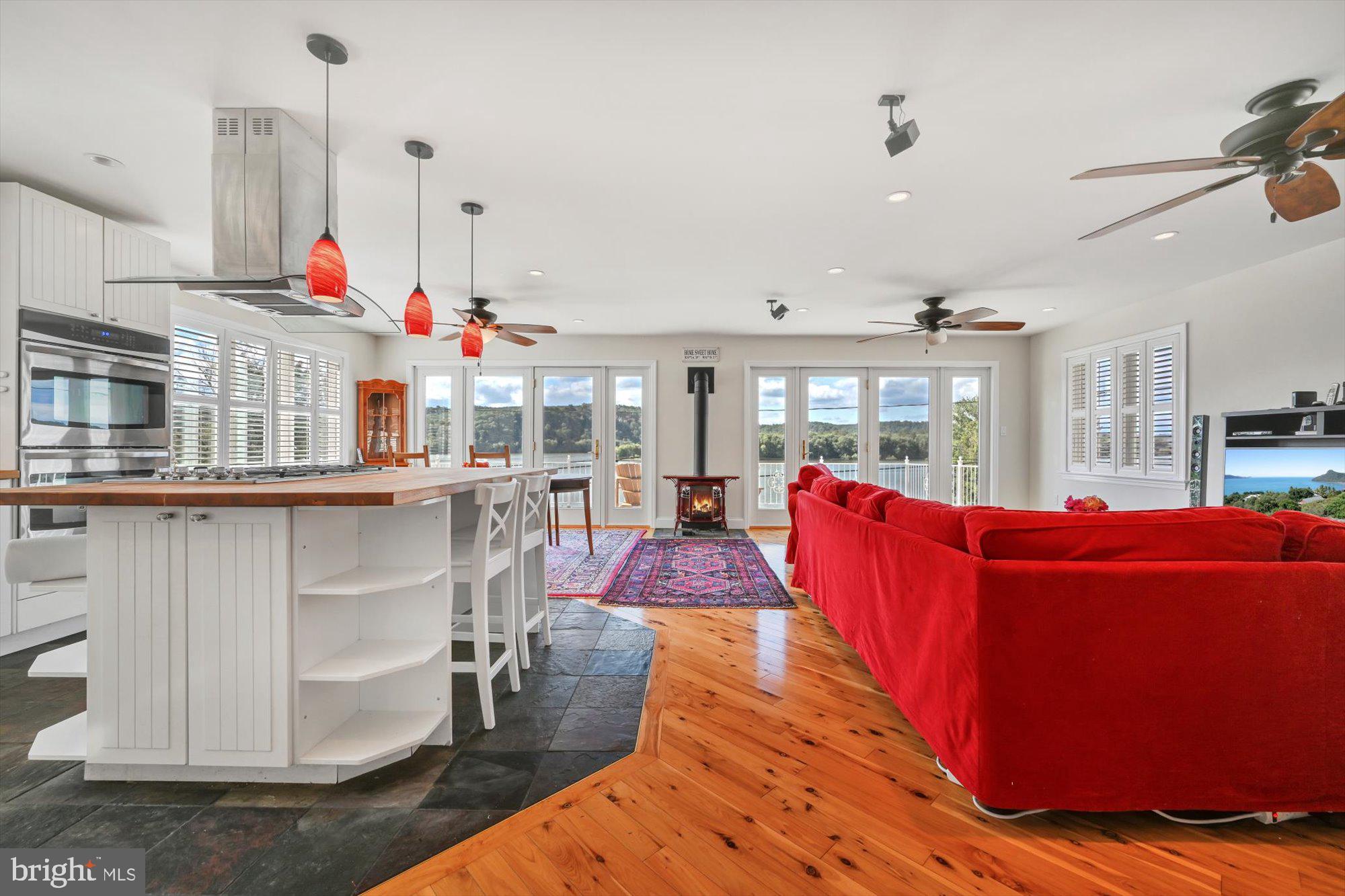 689 Bridge Valley Road Pequea, PA 17565 - Photo 17 of 42 a living room with furniture kitchen view and a wooden floor