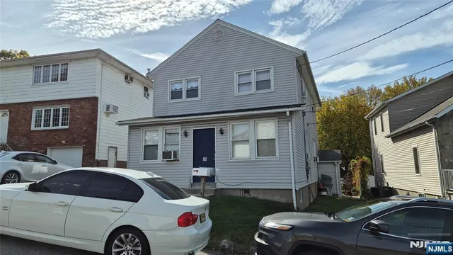 a front view of a house with parking space
