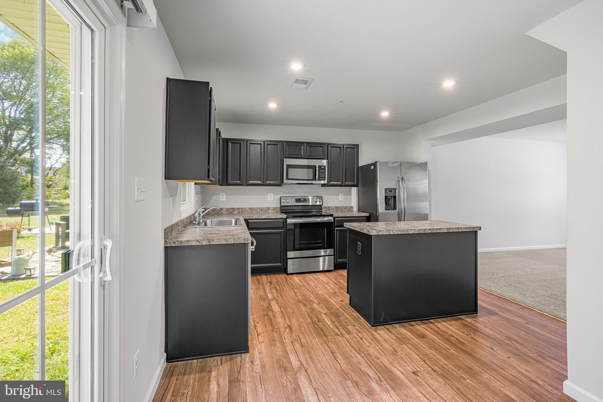 112 Azalea Circle Elkton, MD 21921 - Photo 12 of 34 a kitchen with stainless steel appliances granite countertop a refrigerator and a stove top oven