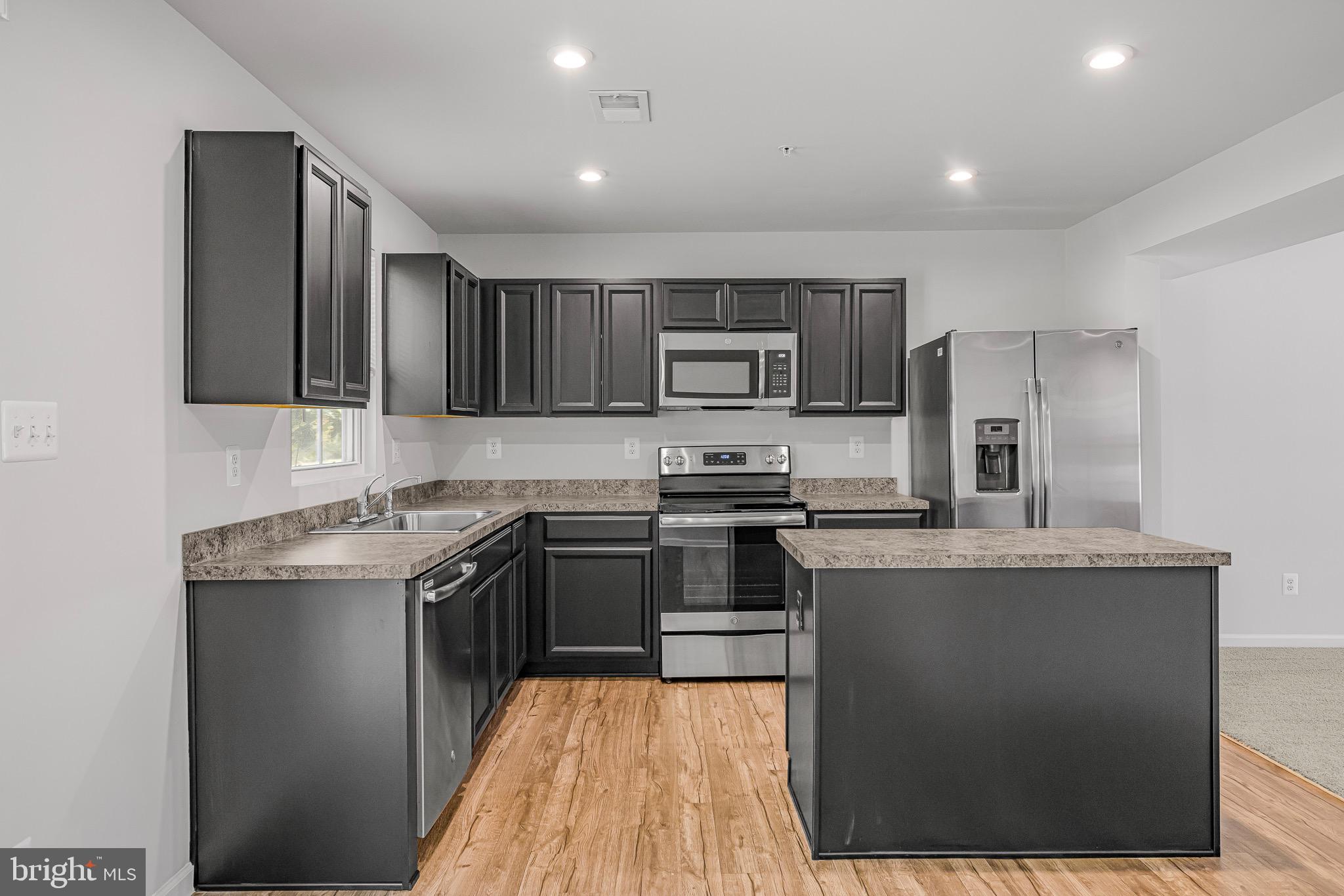 112 Azalea Circle Elkton, MD 21921 - Photo 13 of 34 a kitchen with stainless steel appliances granite countertop a stove top oven a sink and dishwasher