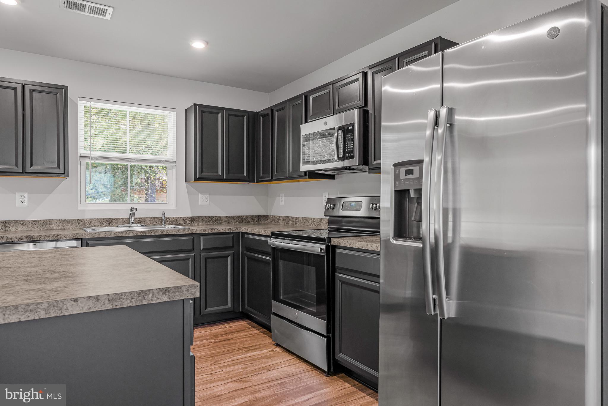 112 Azalea Circle Elkton, MD 21921 - Photo 14 of 34 a kitchen with a refrigerator and a sink