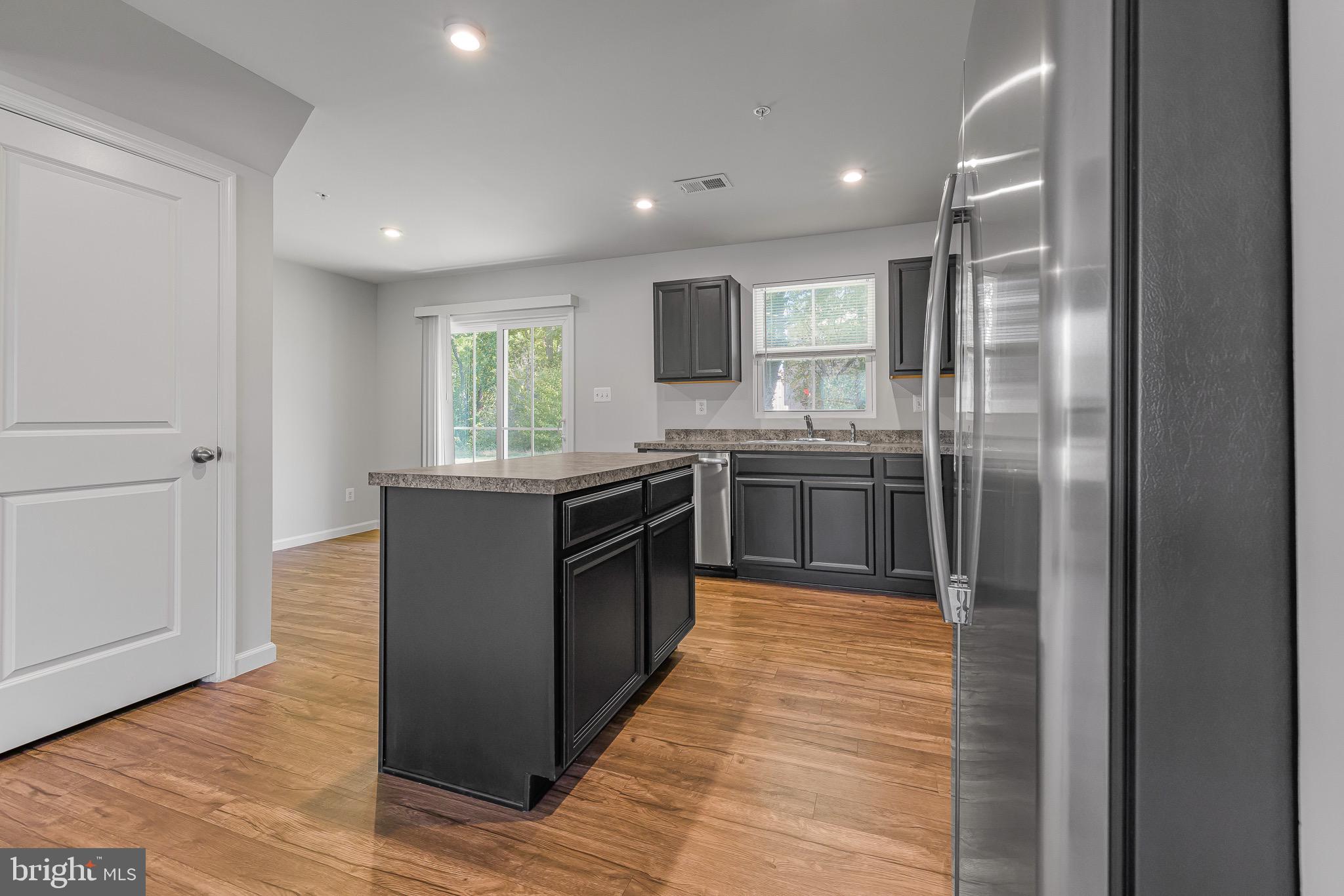 112 Azalea Circle Elkton, MD 21921 - Photo 15 of 34 a kitchen with stainless steel appliances granite countertop a stove a sink and a refrigerator
