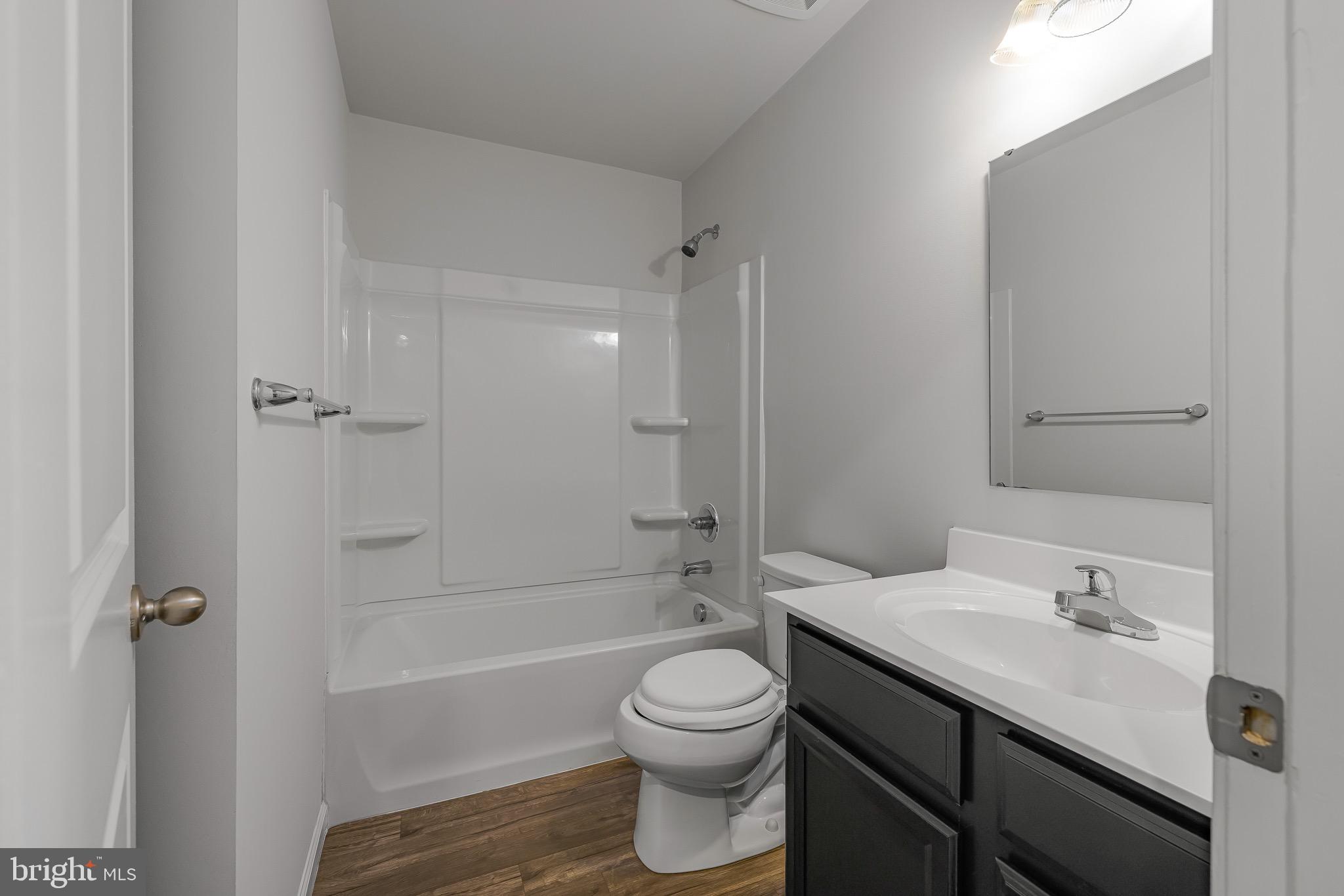 112 Azalea Circle Elkton, MD 21921 - Photo 20 of 34 a bathroom with a bathtub shower sink vanity mirror and toilet