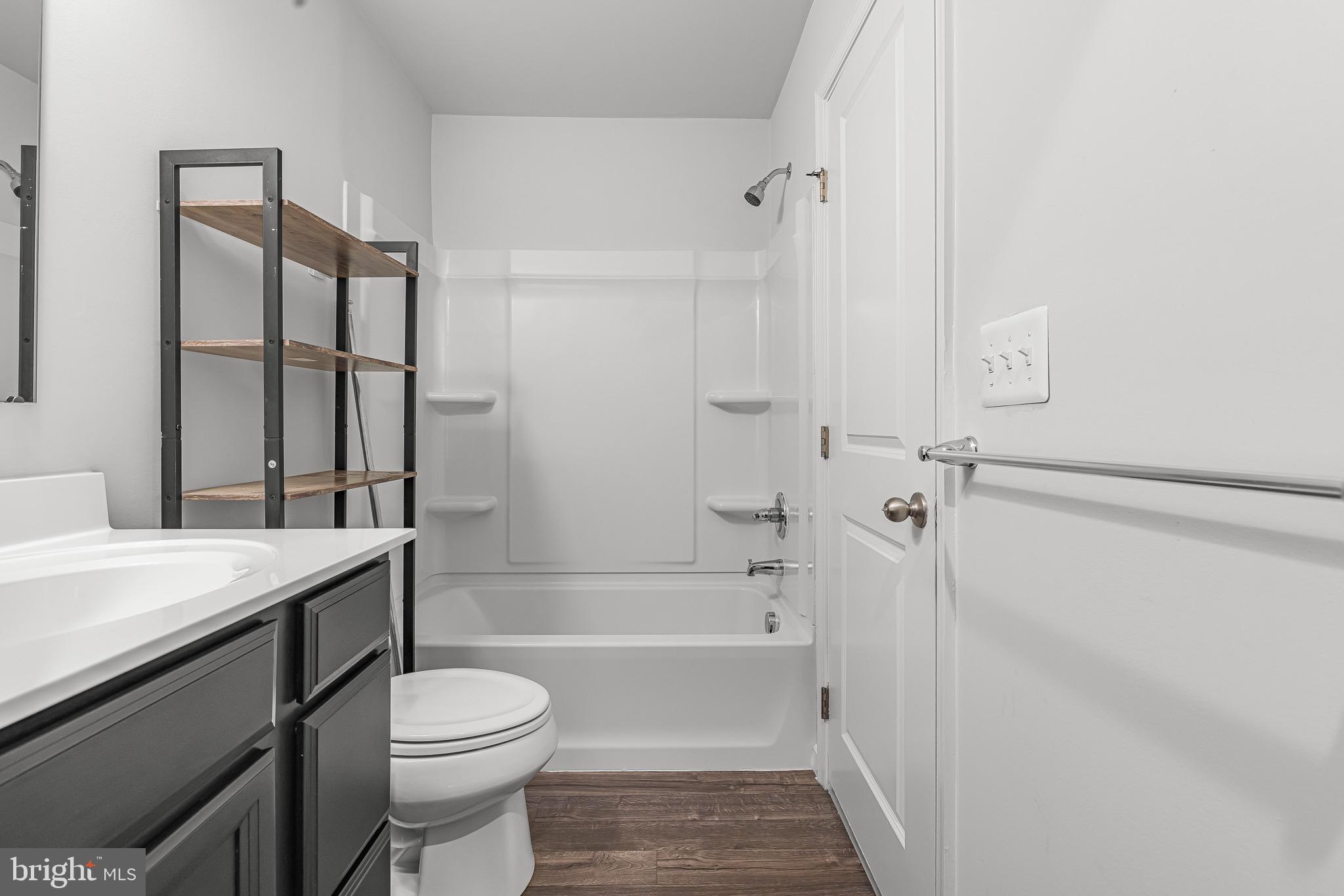 112 Azalea Circle Elkton, MD 21921 - Photo 27 of 34 a bathroom with a granite countertop bathtub shower sink vanity and toilet