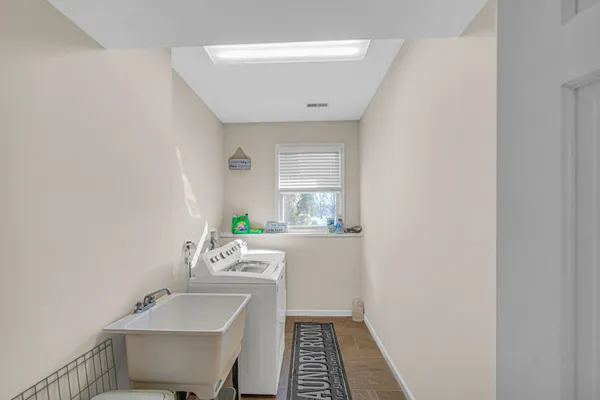 a bathroom with a sink mirror and toilet