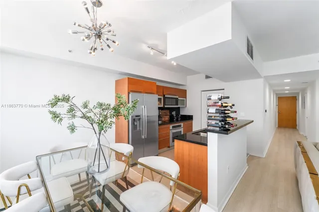 a living room with furniture and a dining table