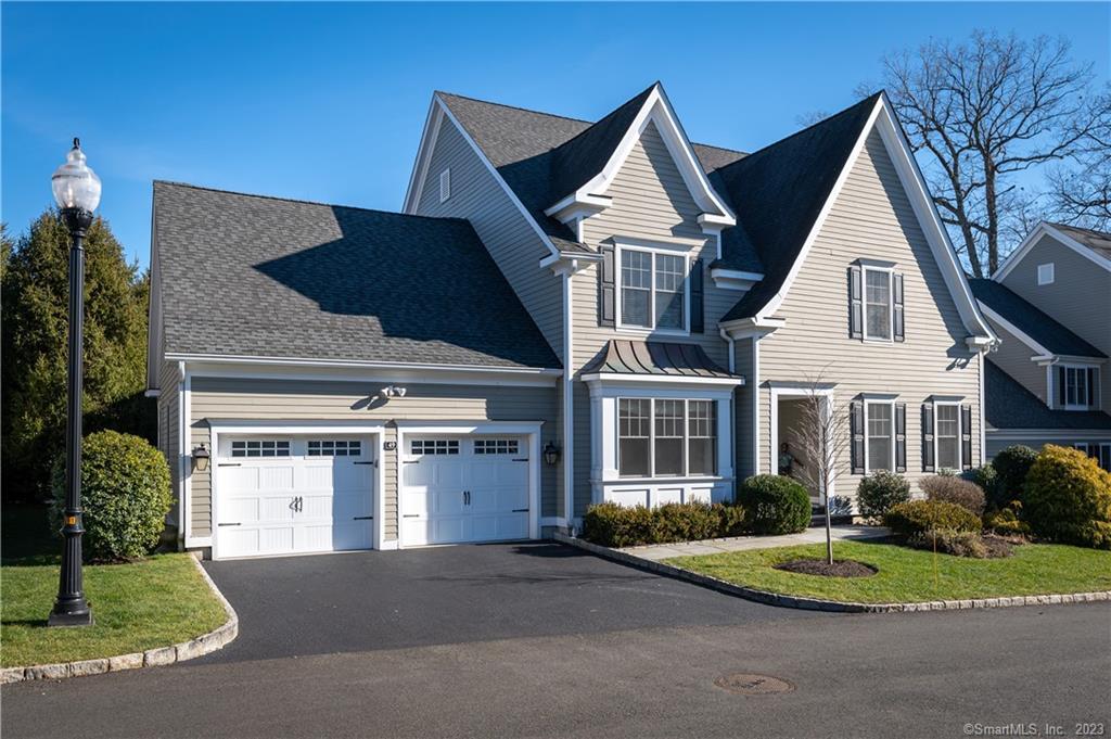 49 Waterview Way Stamford, CT 06902 - Photo 1 of 1 a front view of a house with a yard and garage