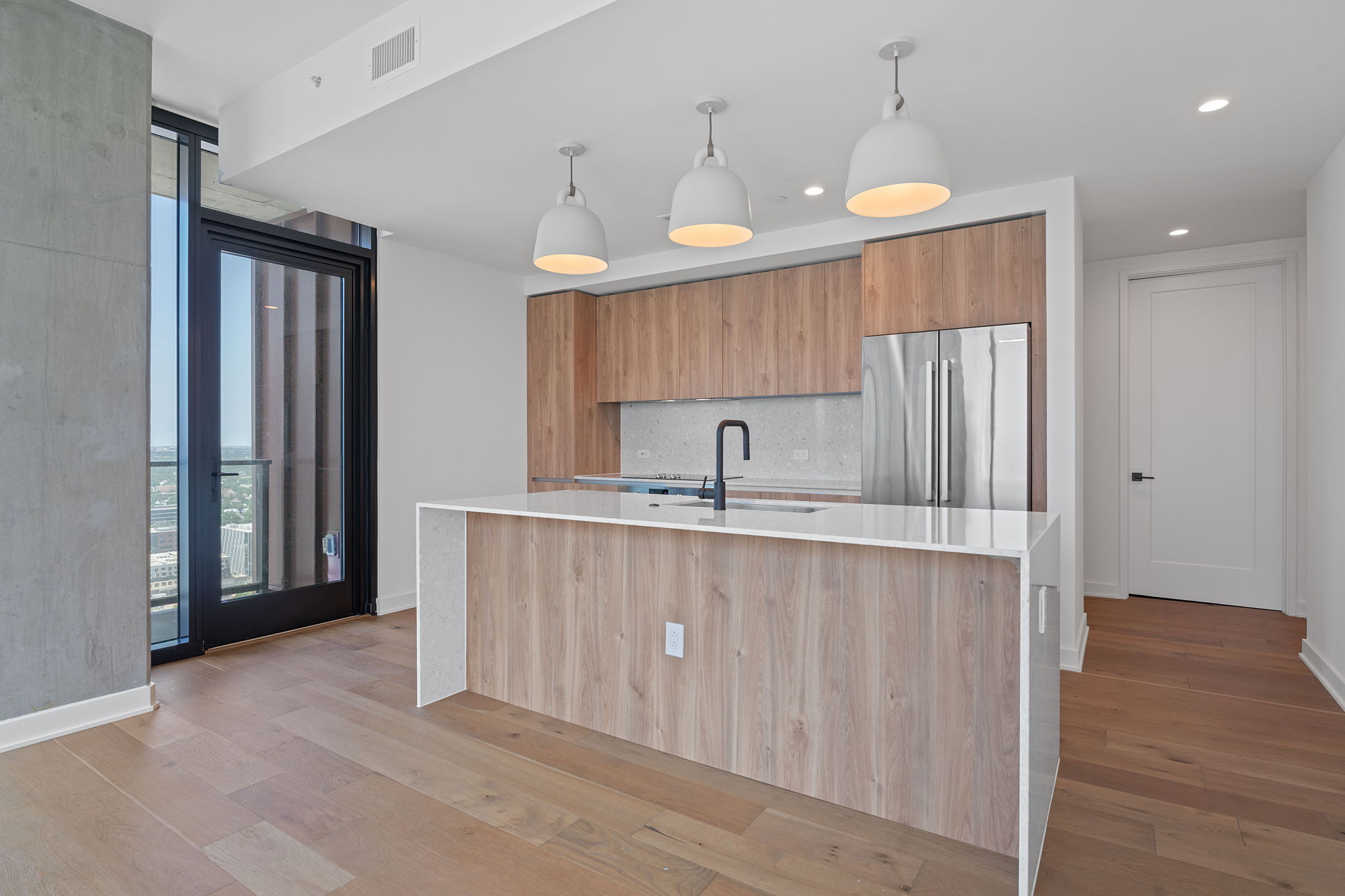 84 East Avenue, Unit 3401 Austin, TX 78701 - Photo 12 of 40 a kitchen with stainless steel appliances granite countertop a refrigerator a sink dishwasher a stove and a refrigerator with wooden floor