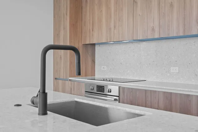 a view of kitchen with stove and cabinets