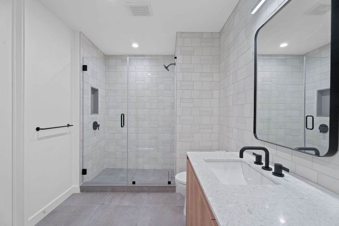 84 East Avenue, Unit 3401 Austin, TX 78701 - Photo 18 of 40 a bathroom with a sink a toilet and shower
