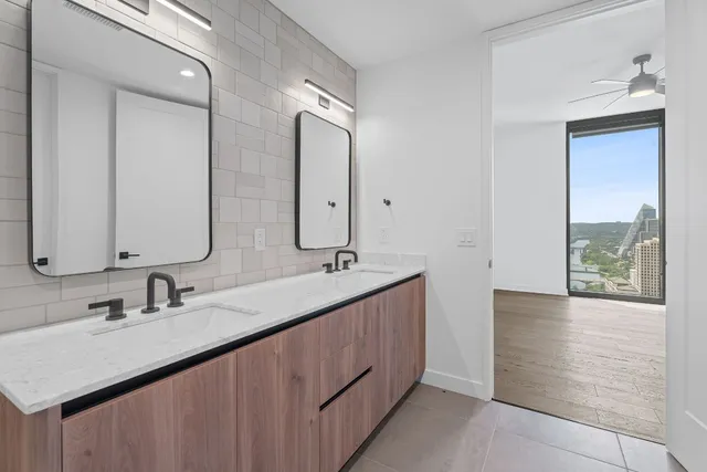 a bathroom with a double vanity sink a and mirror