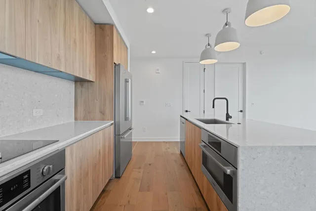 a kitchen with sink a stove and cabinets