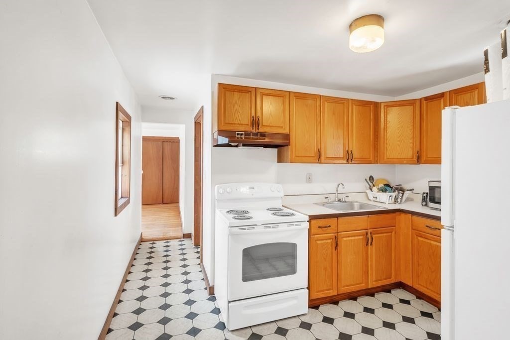 30 Danforth Avenue Pittsfield, MA 01201 - Photo 5 of 25 a kitchen with granite countertop a stove sink and cabinets