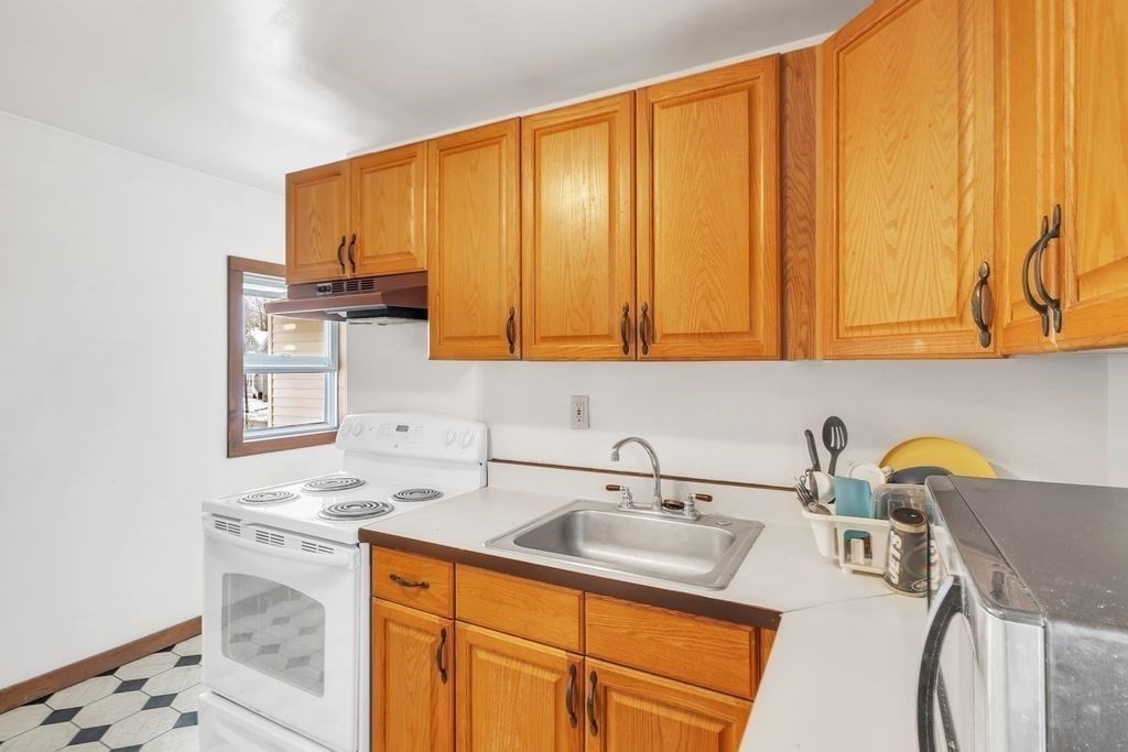 30 Danforth Avenue Pittsfield, MA 01201 - Photo 6 of 25 a kitchen with stainless steel appliances a sink a stove and a microwave