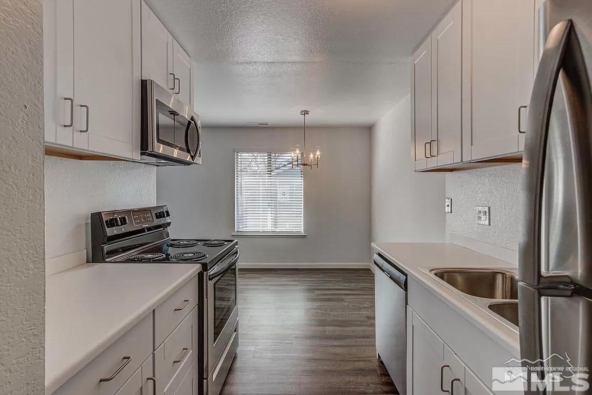 4600 Neil Road, Unit 22 Reno, NV 89502 - Photo 2 of 17 a kitchen with stainless steel appliances granite countertop a stove a sink and a refrigerator