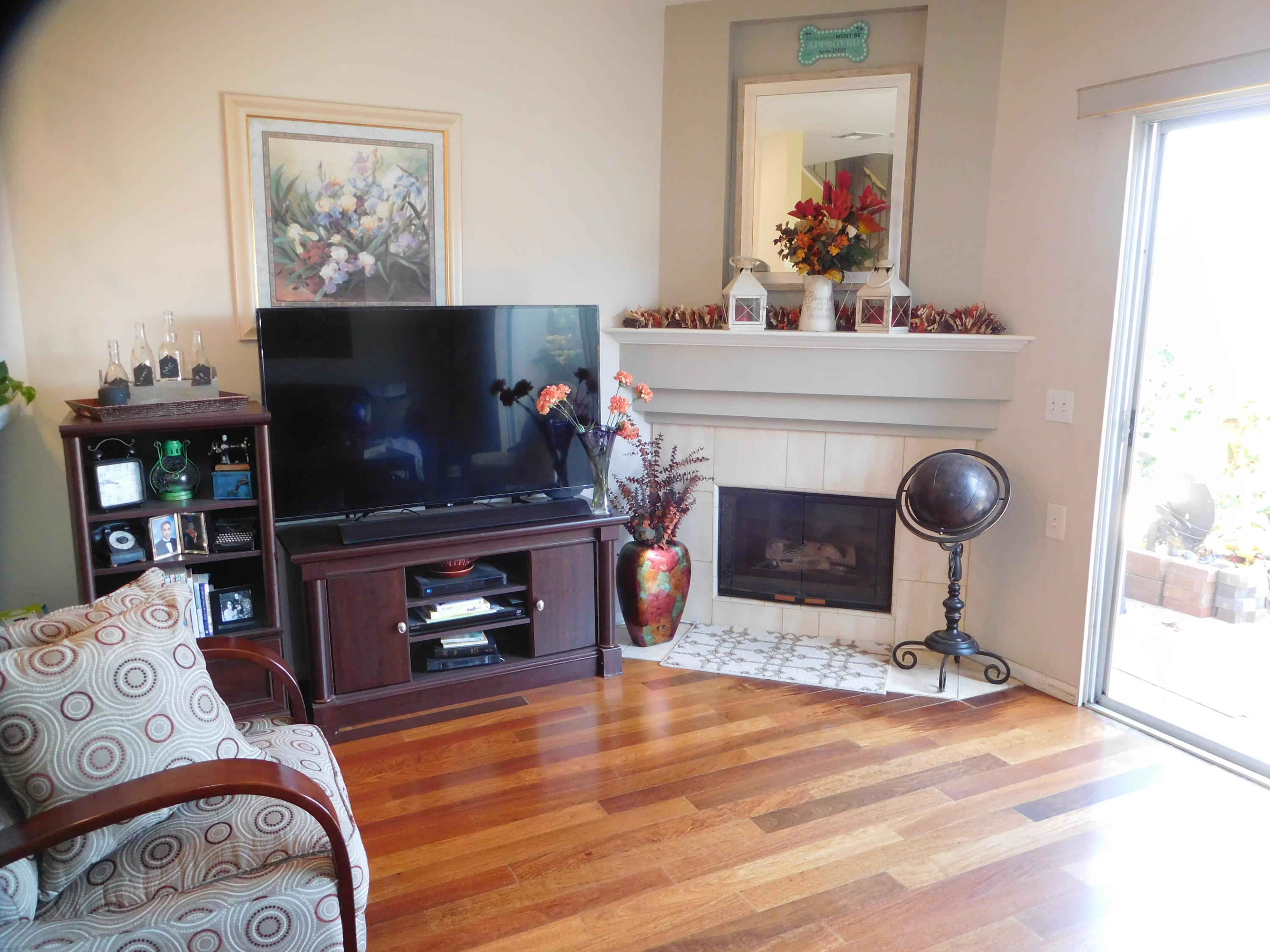 7031 Marymount Way Goleta, CA 93117 - Photo 7 of 9 a living room with furniture a fireplace and a flat screen tv