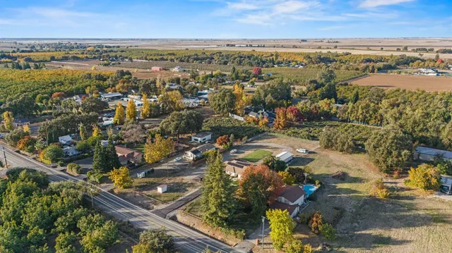 a front view of a house with a yard table and chairs