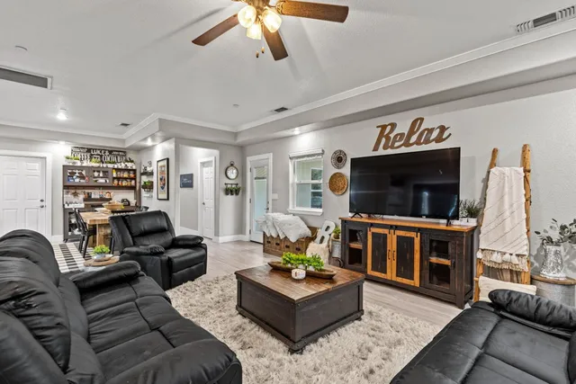 a kitchen with stainless steel appliances granite countertop a kitchen island hardwood floor sink stove dining table and chairs