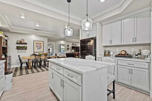 a large white kitchen with cabinets