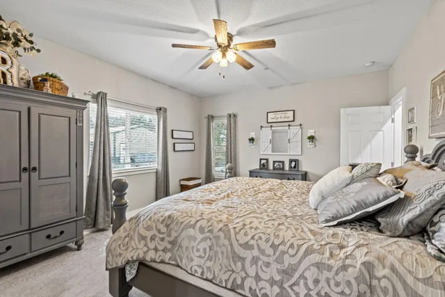 a bedroom with a bed dresser and a window