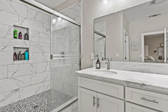 a view of bathroom with a toilet sink and mirror