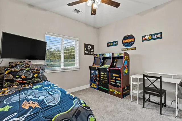 a bedroom with a bed a wall painting and a window