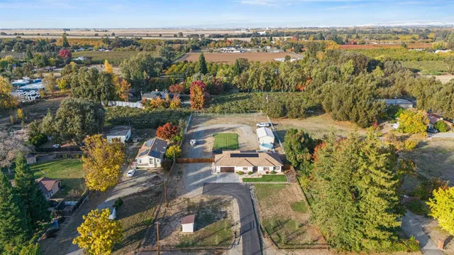 an aerial view of a house with a lake view