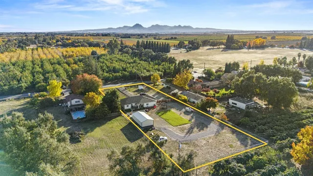 an aerial view of a house with a lake view