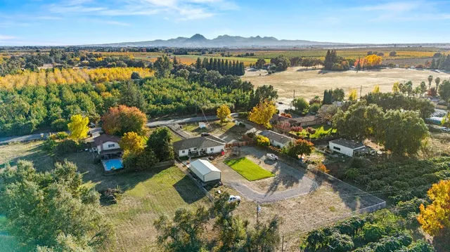 an aerial view of a house with a lake view