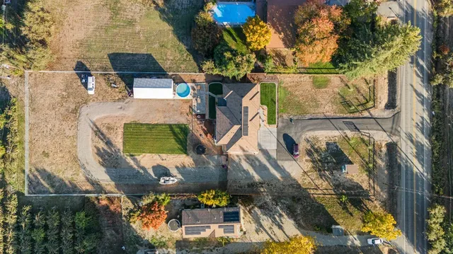an aerial view of a house with outdoor space swimming pool