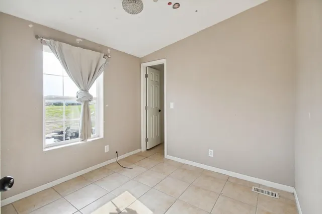 an empty room with windows and closet