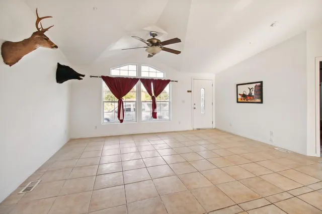 a view of an empty room with a fan