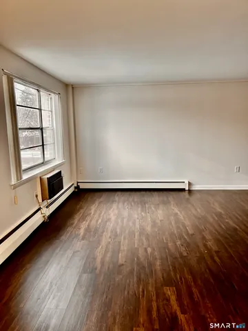 an empty room with wooden floor and closet