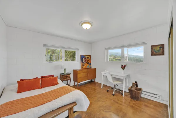 a bedroom with furniture and a wooden floor