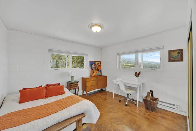 a bedroom with furniture and a wooden floor