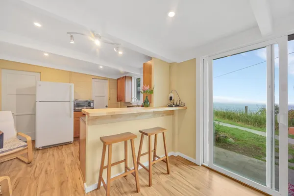 a bathroom with a granite countertop sink and a large mirror
