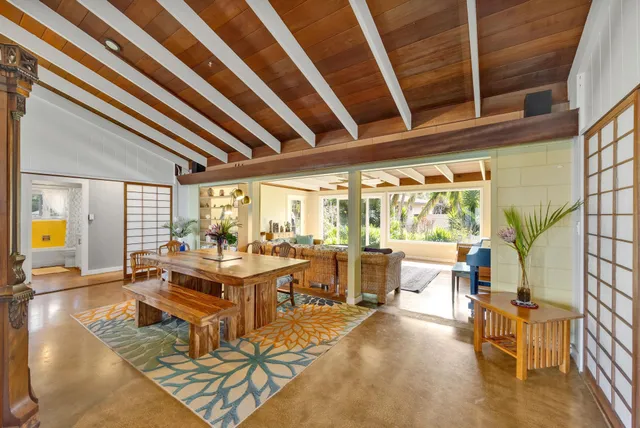 a living room with fireplace furniture and a large window