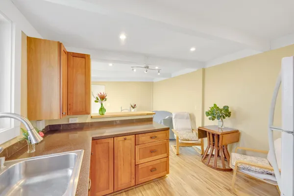 an aerial view of residential houses with outdoor space and trees