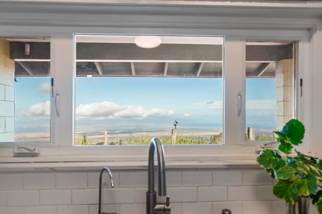 a picture of a bathroom with mirror and window