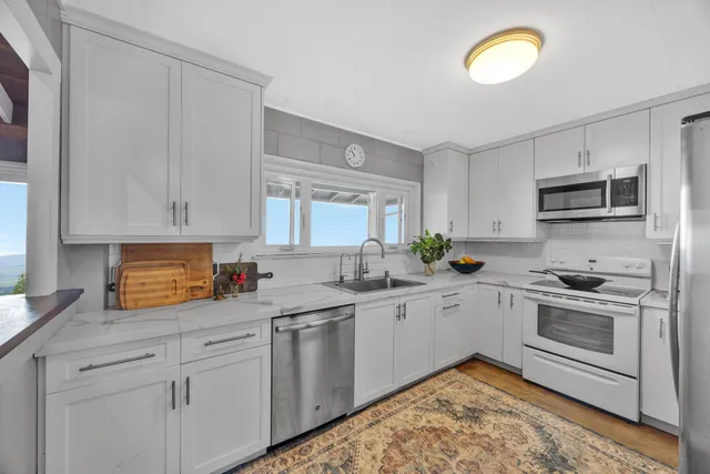 a kitchen with appliances cabinets and a sink