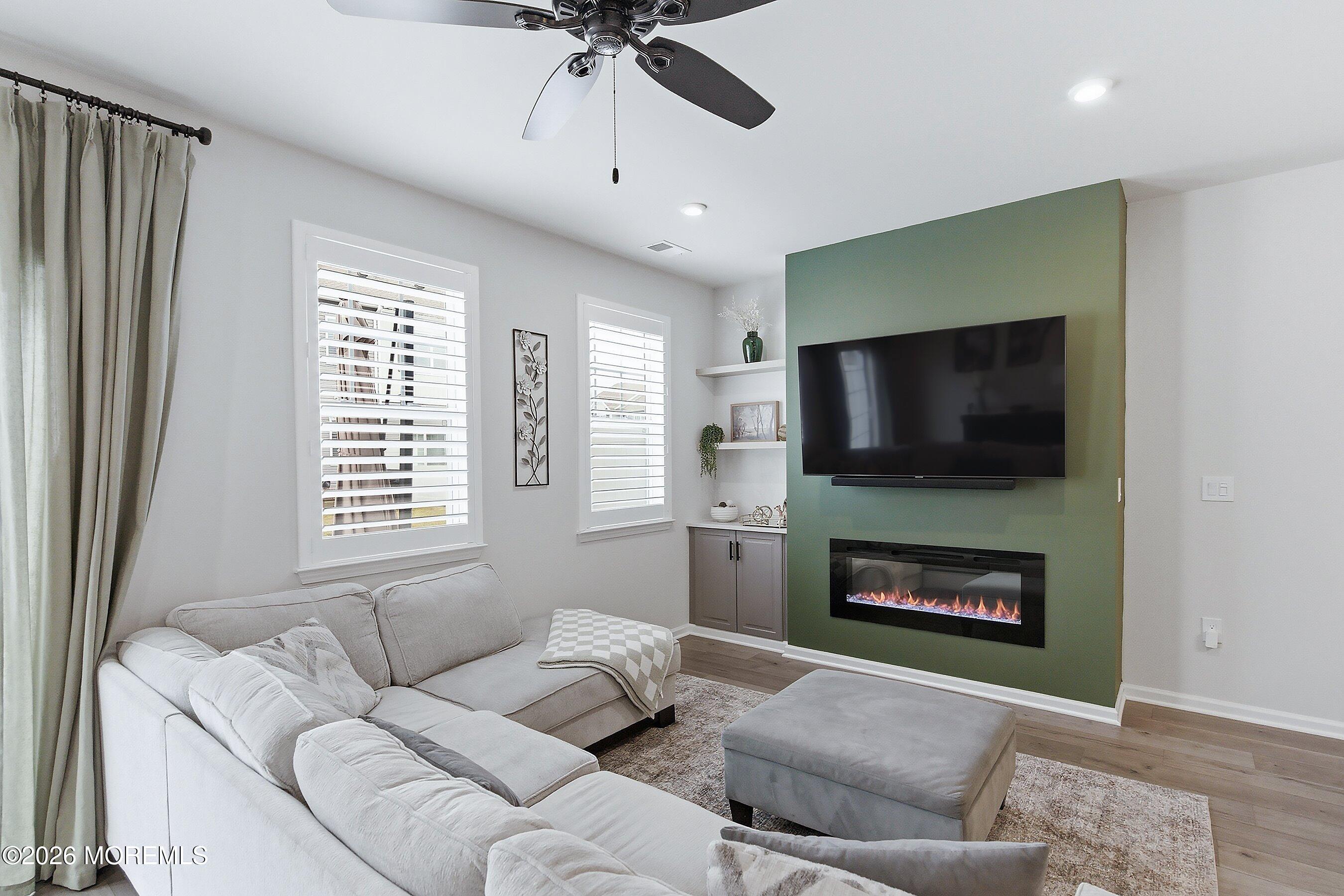 5 Laird Way Neptune, NJ 07753 - Photo 11 of 35 a living room with furniture a flat screen tv and a fireplace