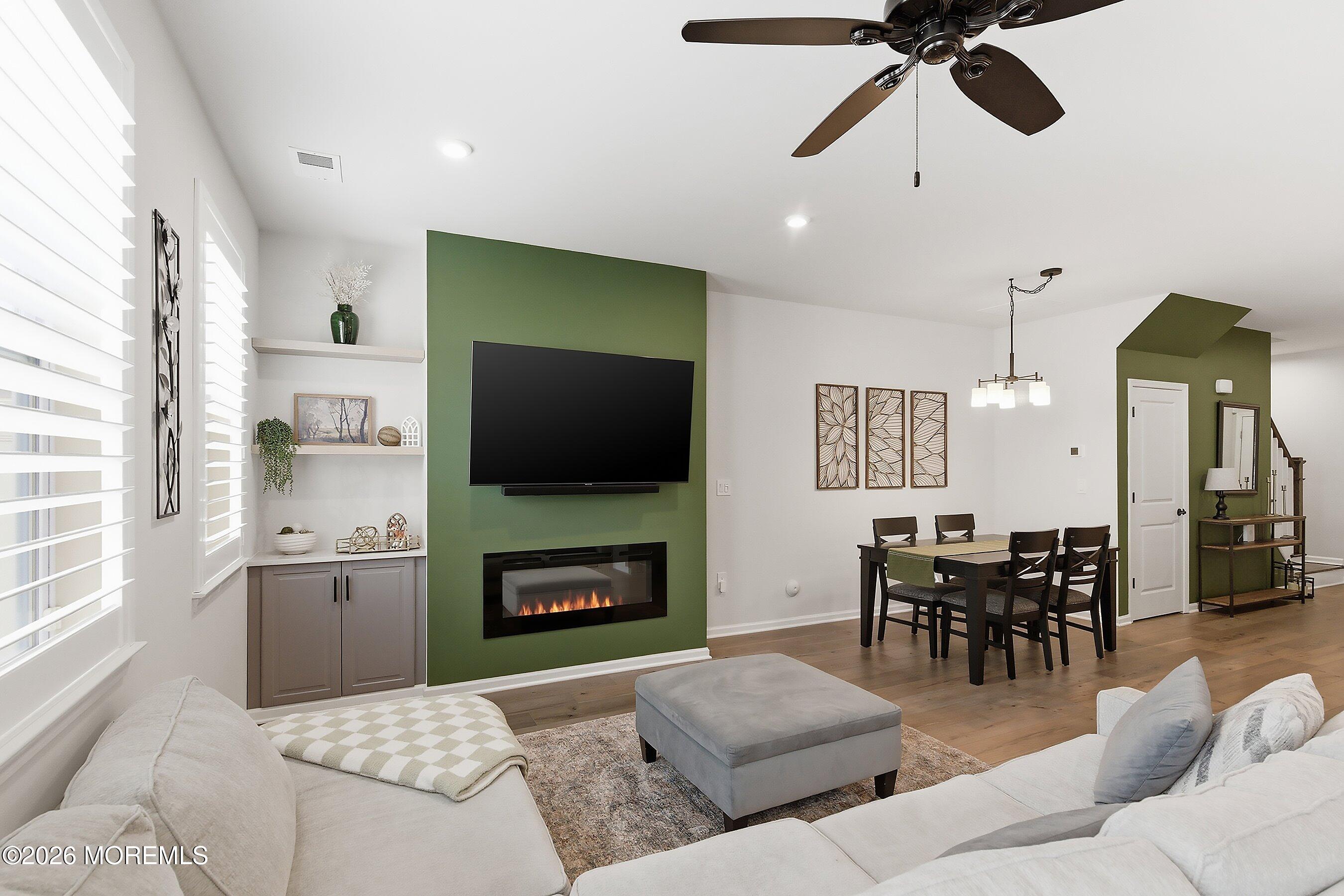 5 Laird Way Neptune, NJ 07753 - Photo 14 of 35 a living room with furniture a fireplace and a flat screen tv