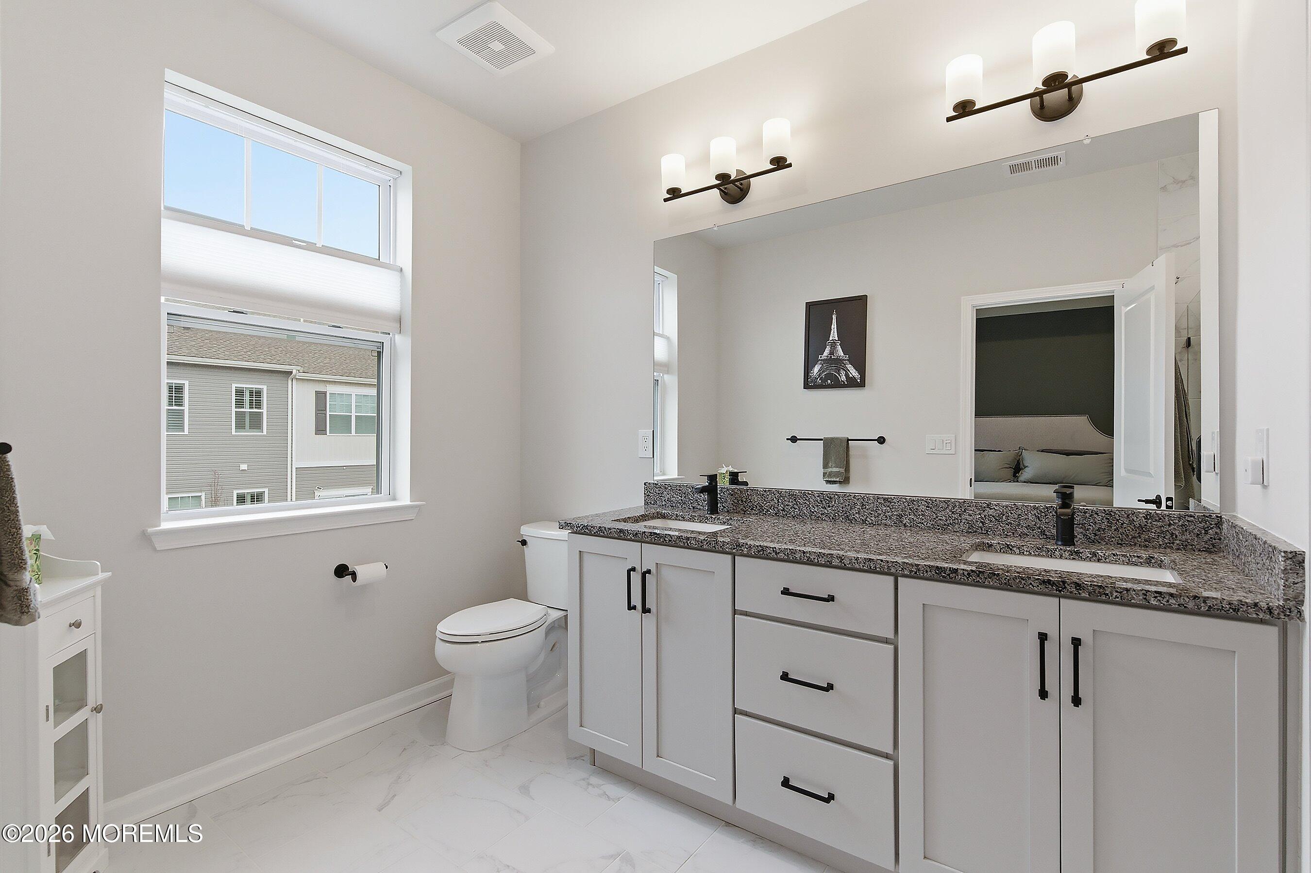 5 Laird Way Neptune, NJ 07753 - Photo 17 of 35 a spacious bathroom with a granite countertop sink a toilet and a mirror