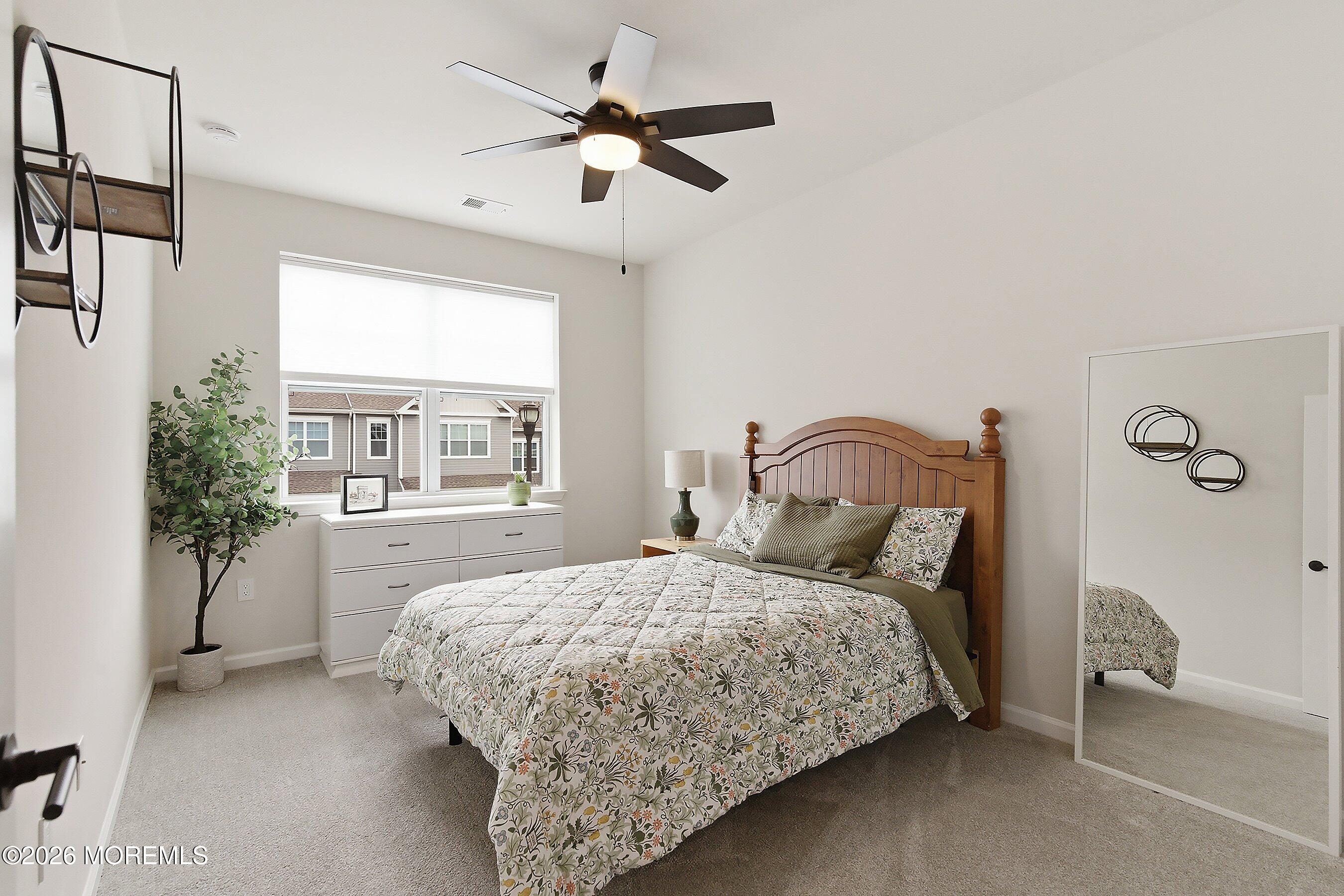 5 Laird Way Neptune, NJ 07753 - Photo 19 of 35 a bedroom with a bed next to a window and a potted plant