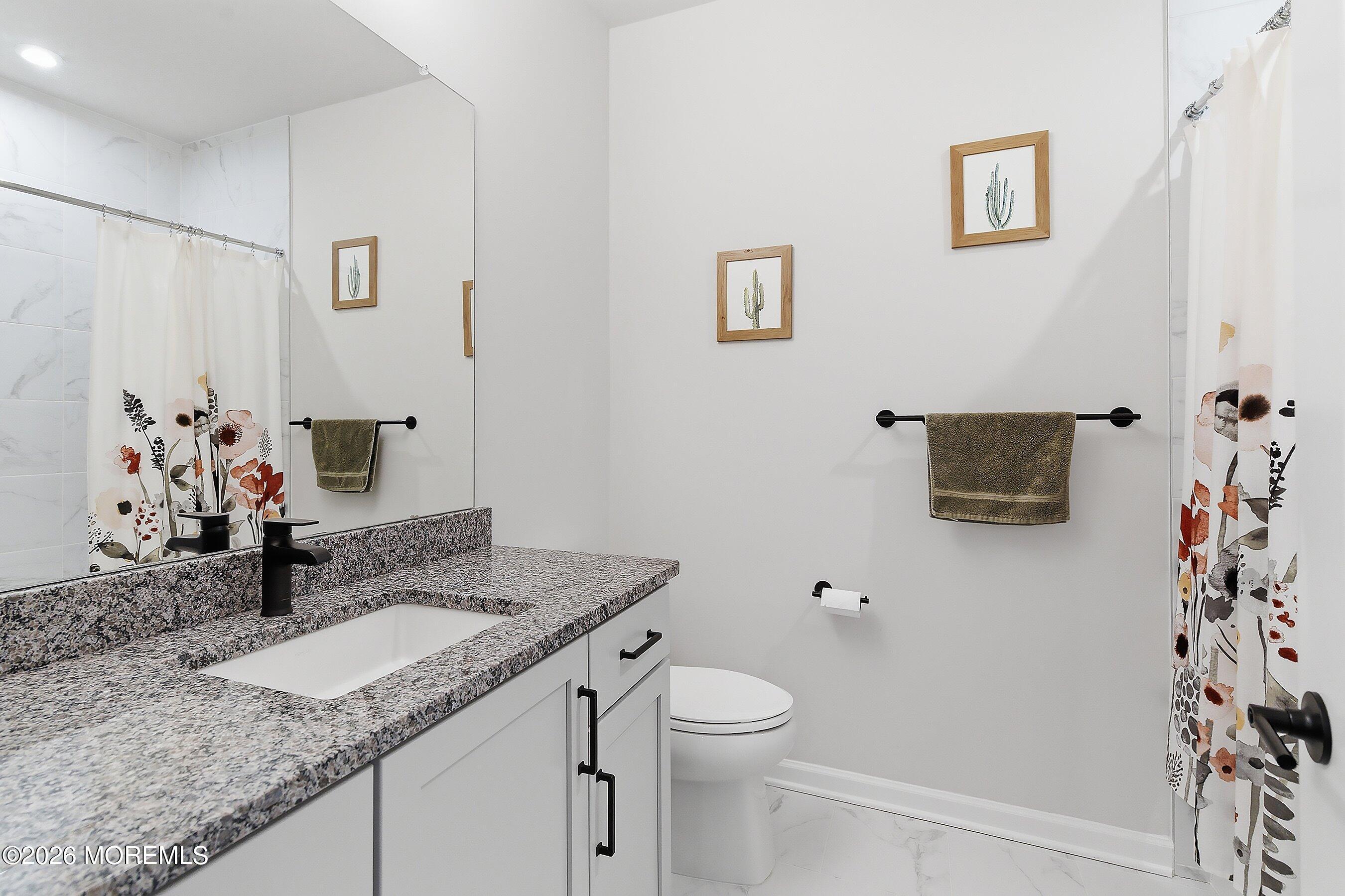 5 Laird Way Neptune, NJ 07753 - Photo 21 of 35 a bathroom with a granite countertop sink and a mirror