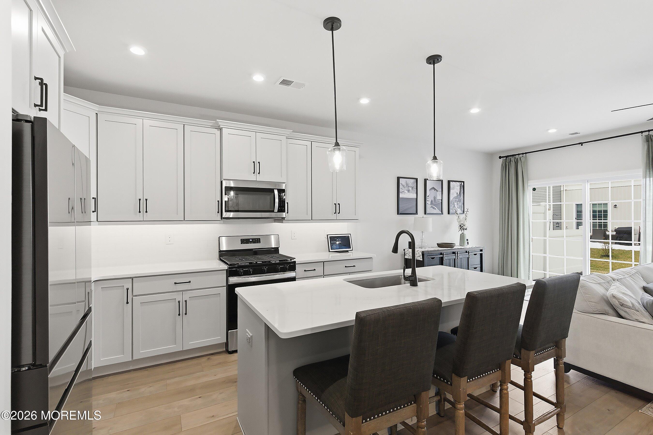 5 Laird Way Neptune, NJ 07753 - Photo 6 of 35 a kitchen with a sink stainless steel appliances and white cabinets