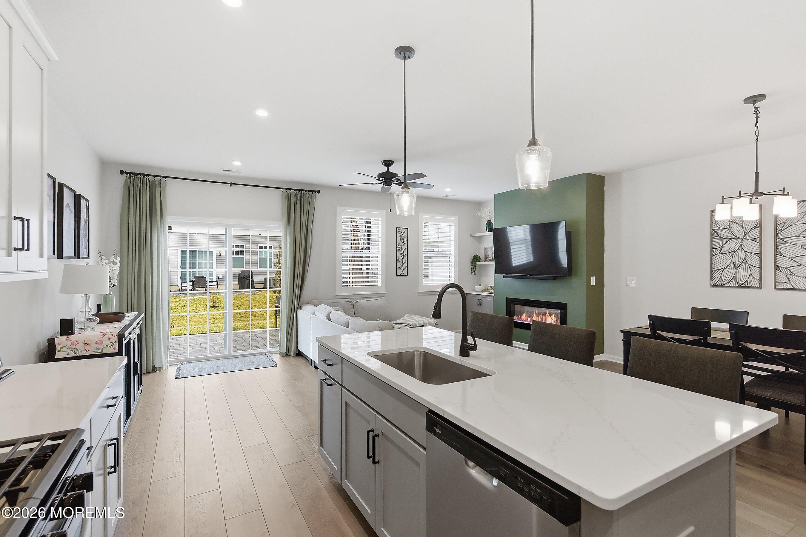 5 Laird Way Neptune, NJ 07753 - Photo 9 of 35 a large kitchen with kitchen island a large counter space a sink appliances and living room view
